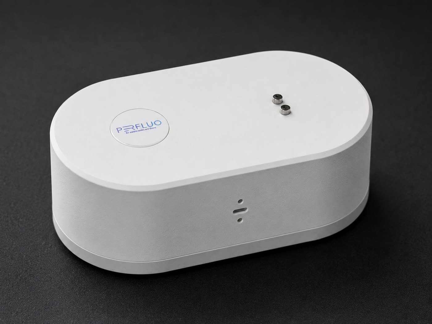 Perfluo water leak alarm overhead view — compact rounded design fits under any sink